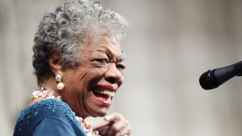 Maya Angelou speaking at a microphone