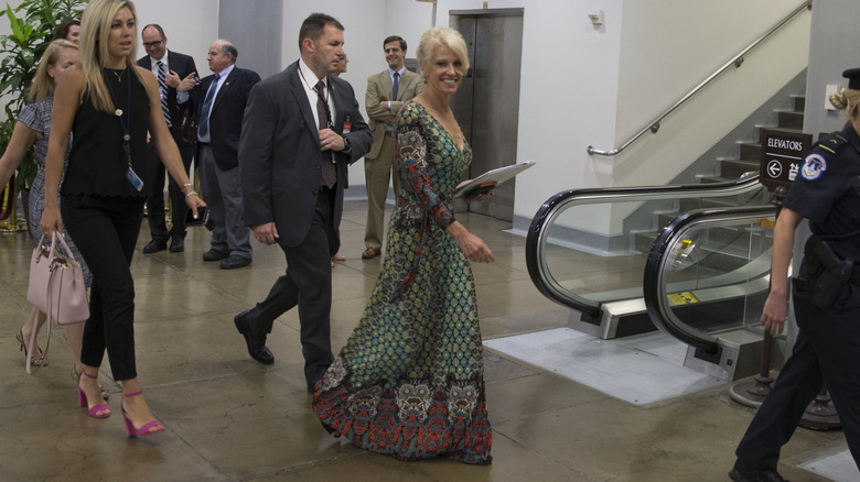 Kellyanne Conway pictured with a group of people at the bottom of an escalator