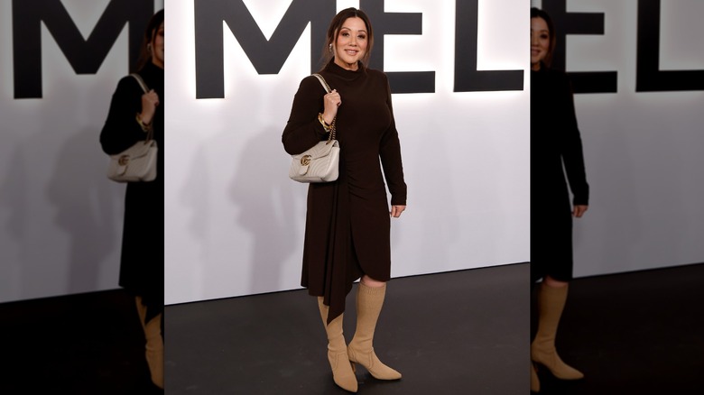 Secretary of Labor Lori Chavez-DeRemer poses for a photo at the Melania movie premiere dressed in a black dress with tan sock boots