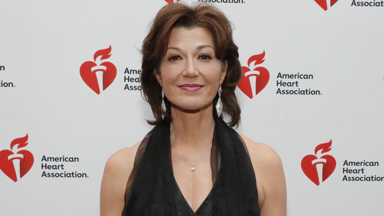 Amy Grant posing in red at American Heart Association event