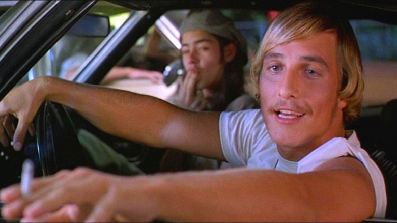 David Wooderson (Matthew McConaughey) behind the wheel, leaning out of the car window, in "Dazed and Confused"
