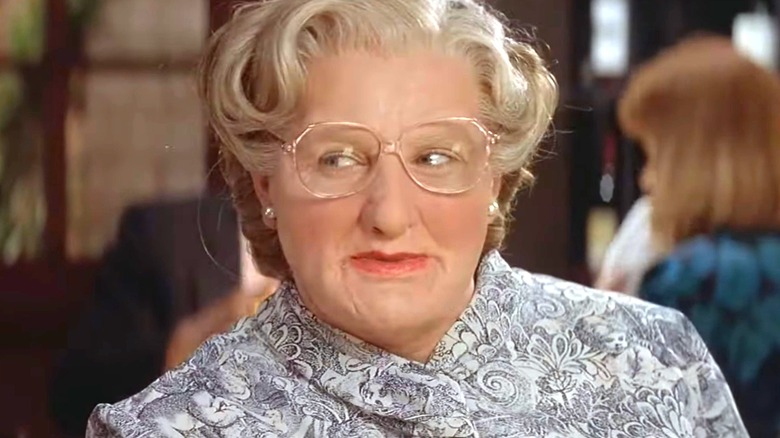 A close-up of Robin Williams as Mrs. Doubtfire at a restaurant in the eponymous film