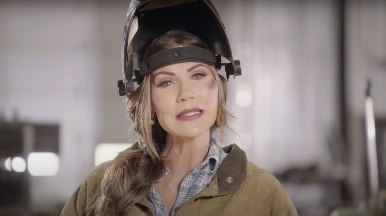 Kristi Noem wears a welder's helmet