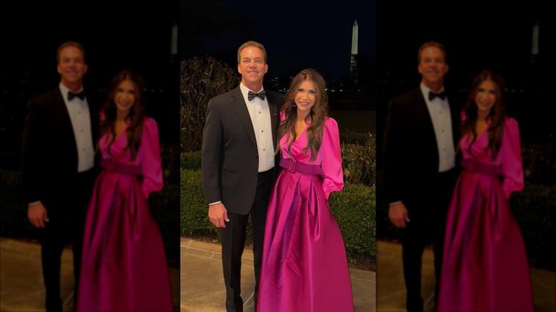 Kristi Noem wears a pink dress standing next to Byron Noem