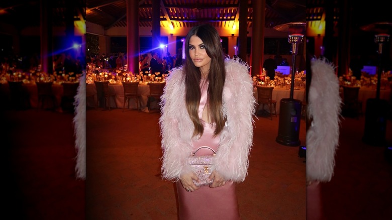 Kimberly Guilfoyle poses for a photo at an event in a pink dress and feathery jacket