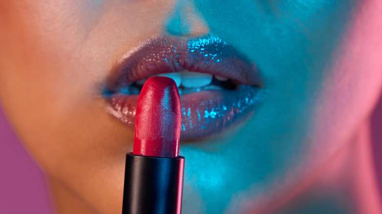 Woman applying lipstick