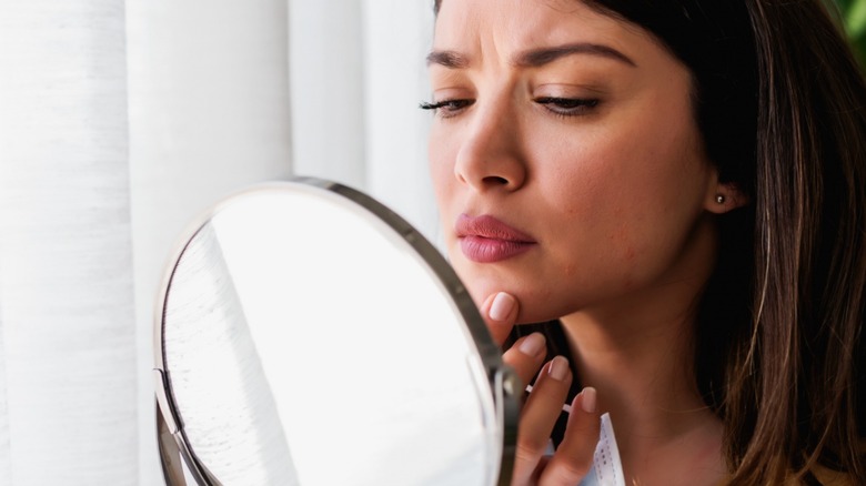 Woman checking for blemishes