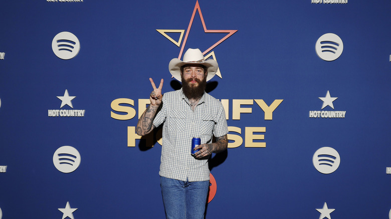 Post Malone holding up a peace sign