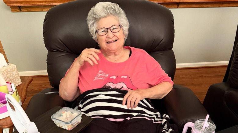 Belle sitting in a chair with a blanket