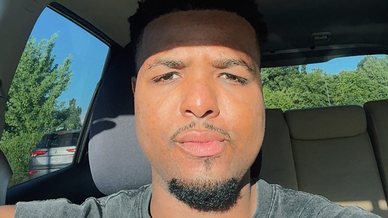 Malik Taylor poses in a tuxedo