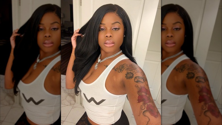 Selfie of Alysha Burney wearing a white tank top