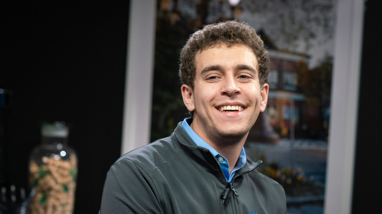 Daniel Naroditsky smiling in a US Chess jacket