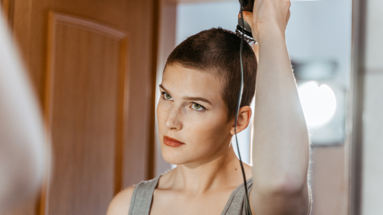 Woman shaving her head