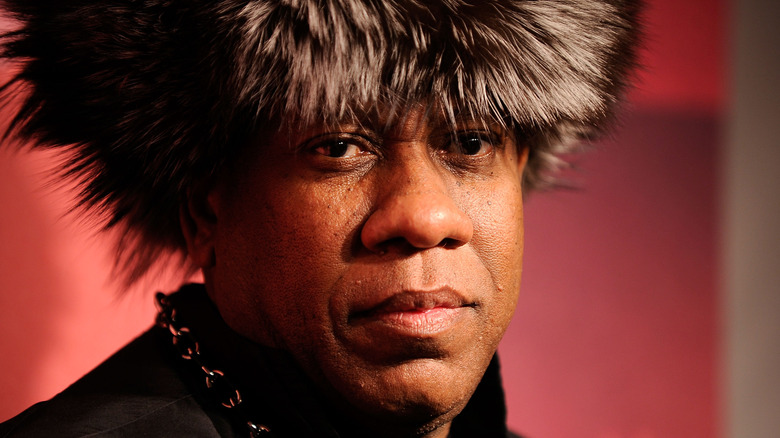 Andre Leon Talley wearing a fur hat looking into the distance