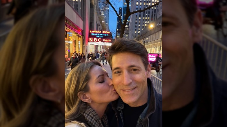 An Instagram photo from Katy Tur showing her kissing her husband, Tony Dokoupil, on the cheek. The entrance to NBC Studios is behind them.