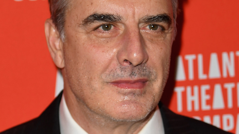 Chris Noth with serious expression on the red carpet