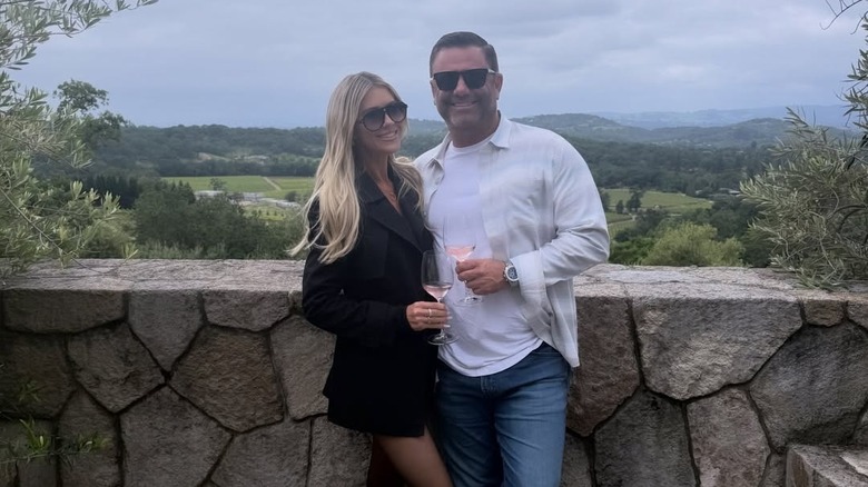 Christina Haack and Christopher Larocca posing together in California's Napa Valley with wine glasses