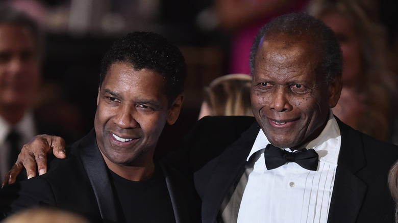 Denzel Washington and Sidney Poitier arm in arm