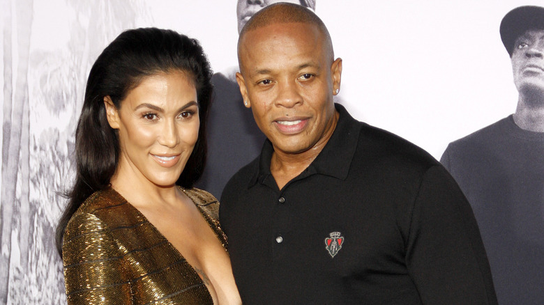 Dr. Dre arriving at event with Nicole Young