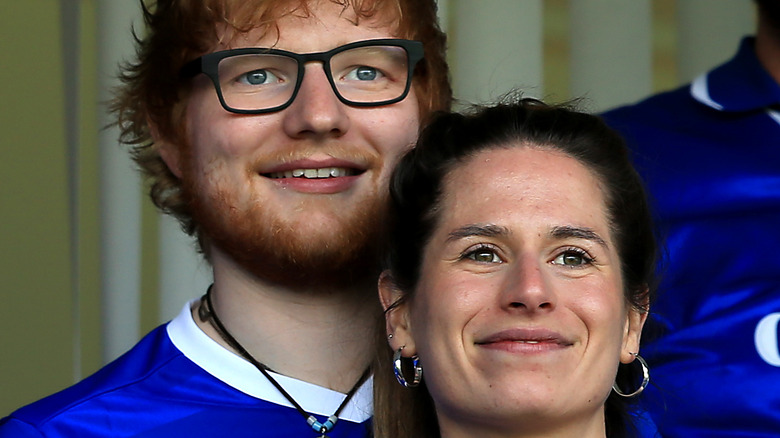 Ed Sheeran and Cherry Seaborn watching a championship match