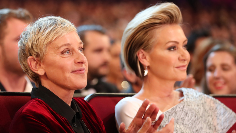 Ellen DeGeneres seated with Portia de Rossi