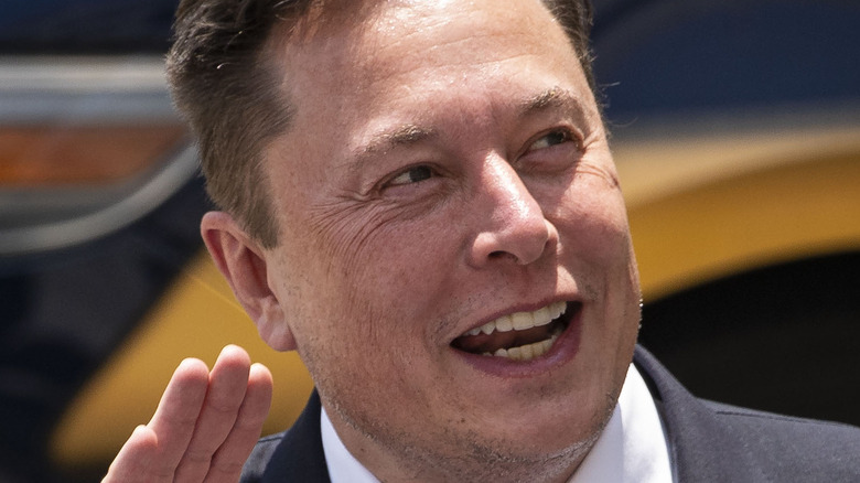 Elon Musk waving and smiling