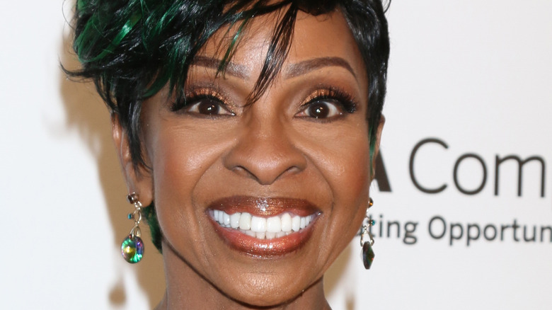 Gladys Knight smiling widely on a red carpet