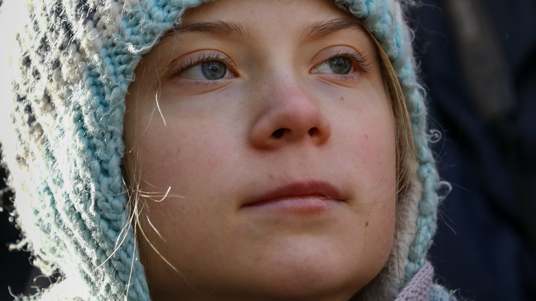 Greta Thunberg looking serious in knit hat