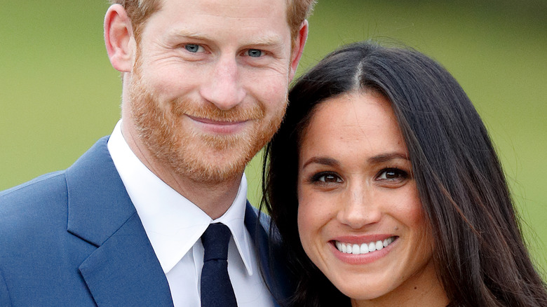 Prince Harry and Meghan Markle pose for pictures during their engagement announcement 