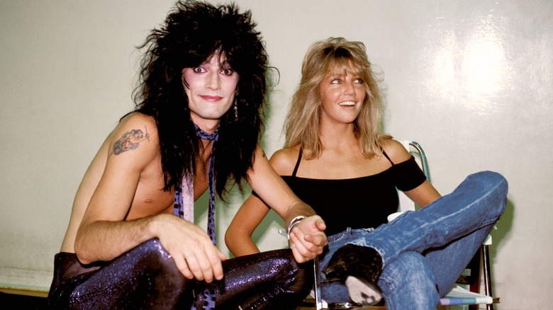 Tommy Lee and Heather Locklear sitting down 