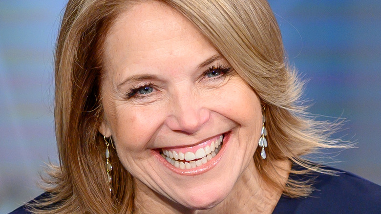 Katie Couric sits behind the news desk 