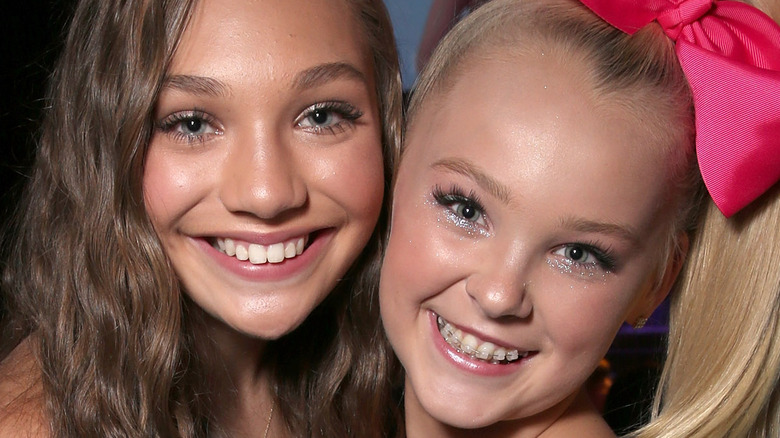 Maddie Ziegler and Jojo Siwa smiling