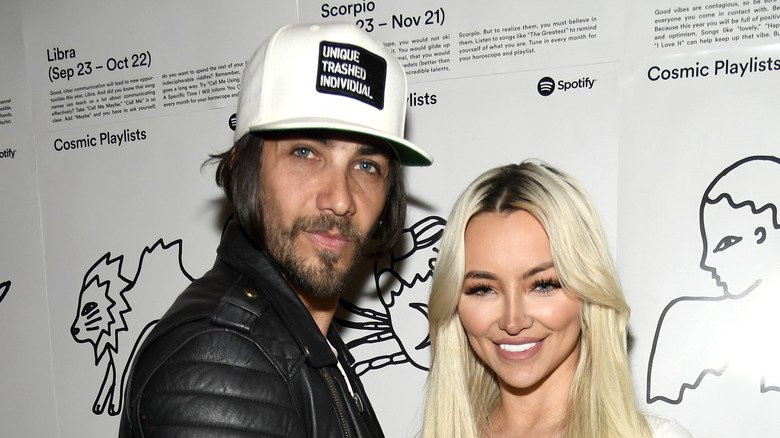 Justin Brescia and Lindsey Pelas pose together at an event