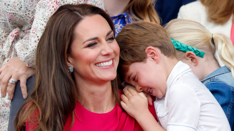 Prince Louis cuddling Princess Catherine smiling