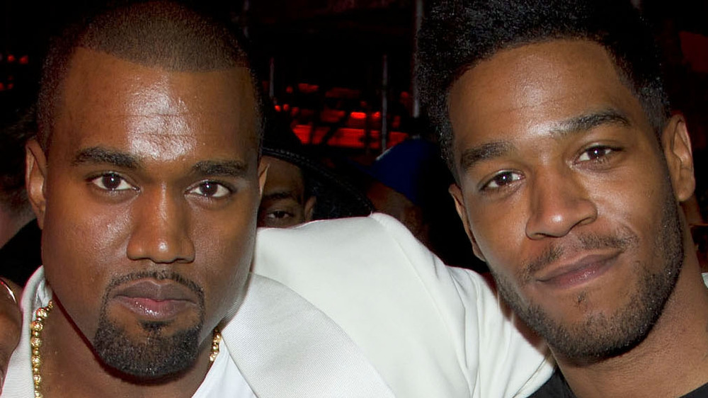 Kid Cudi and Kanye West pose at an event together