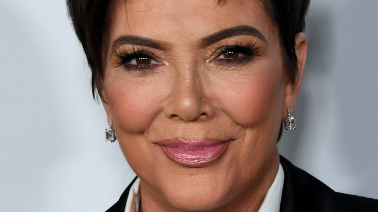 Kris Jenner grinning with diamond earrings