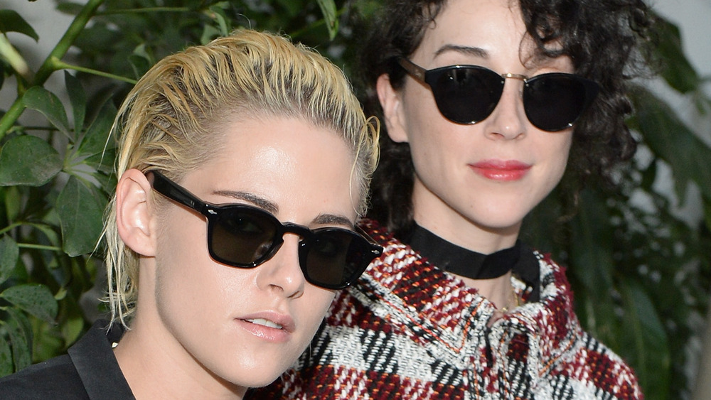 Kristen Stewart and St. Vincent wearing sunglasses at a fashion show