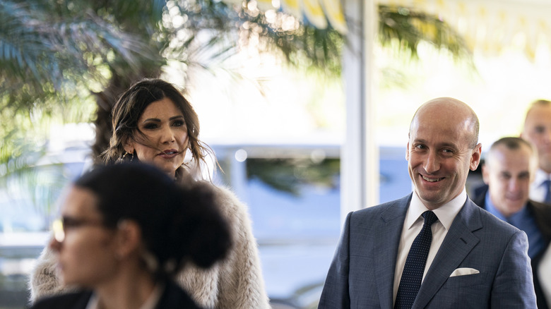 Kristi Noem and Stephen Miller walking into Mar-a-Lago in February 2026