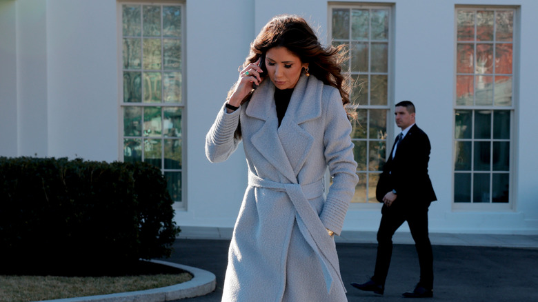 Kristi Noem walking and talking on a cellphone in January 2026