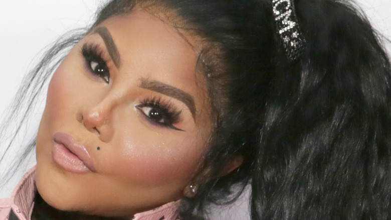 Lil Kim poses at an event