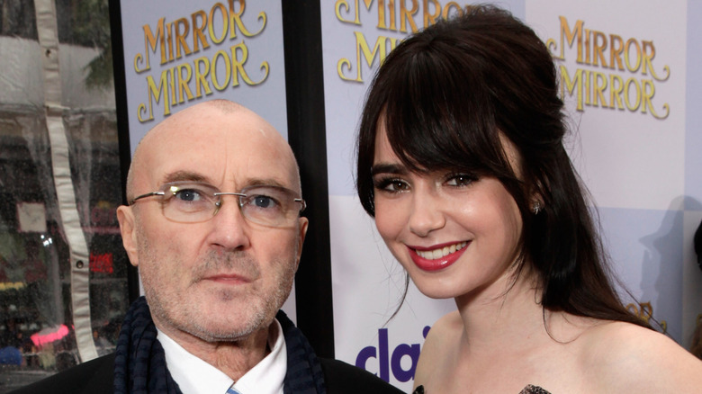 Phil Collins and Lily Collins posing together