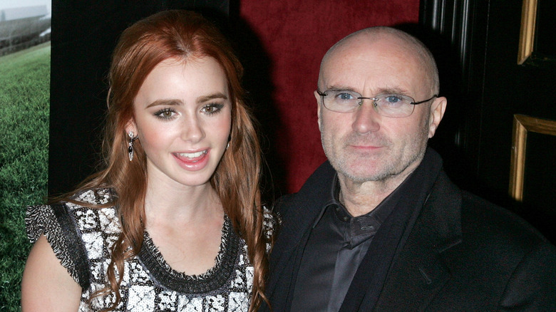 Lily Collins and Phil Collins smiling