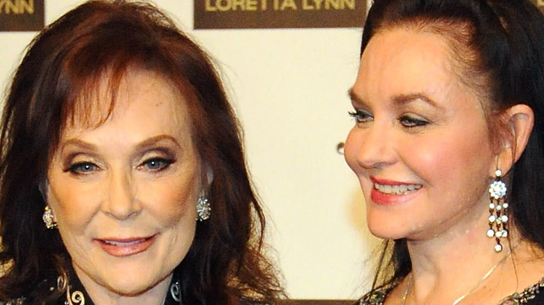 Loretta Lynn and Crystal Gayle smiling 