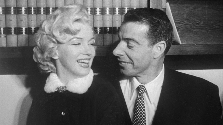Marilyn Monroe and Joe DiMaggio smiling
