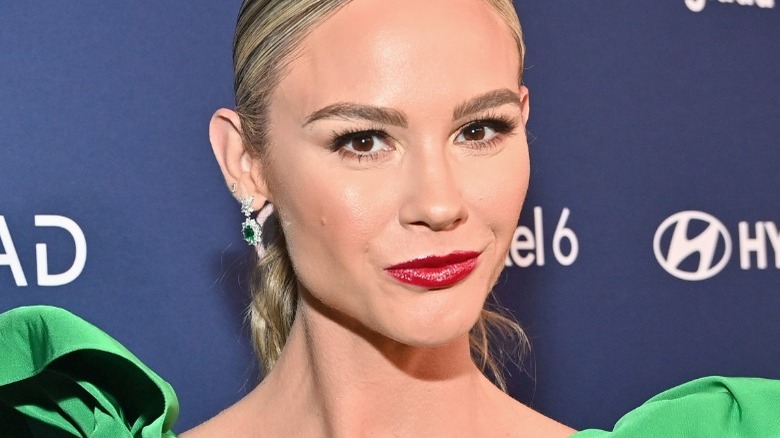 Meghan King smiling wearing red lipstick 