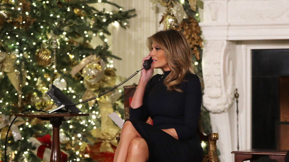 Melania in front of a Christmas tree