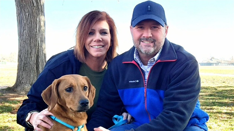 Meri Brown posing with boyfriend and dog