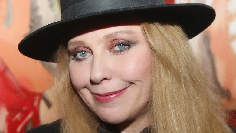 Bebe Buell smiles with her mouth closed 