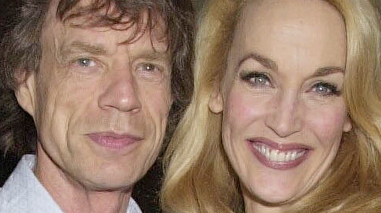 Mick Jagger smiles alongside Jerry Hall