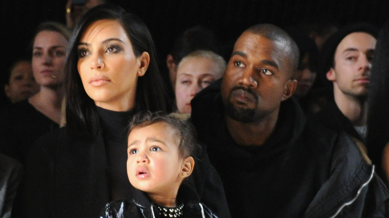 Kim Kardashian, Kanye West, and North West at a fashion show